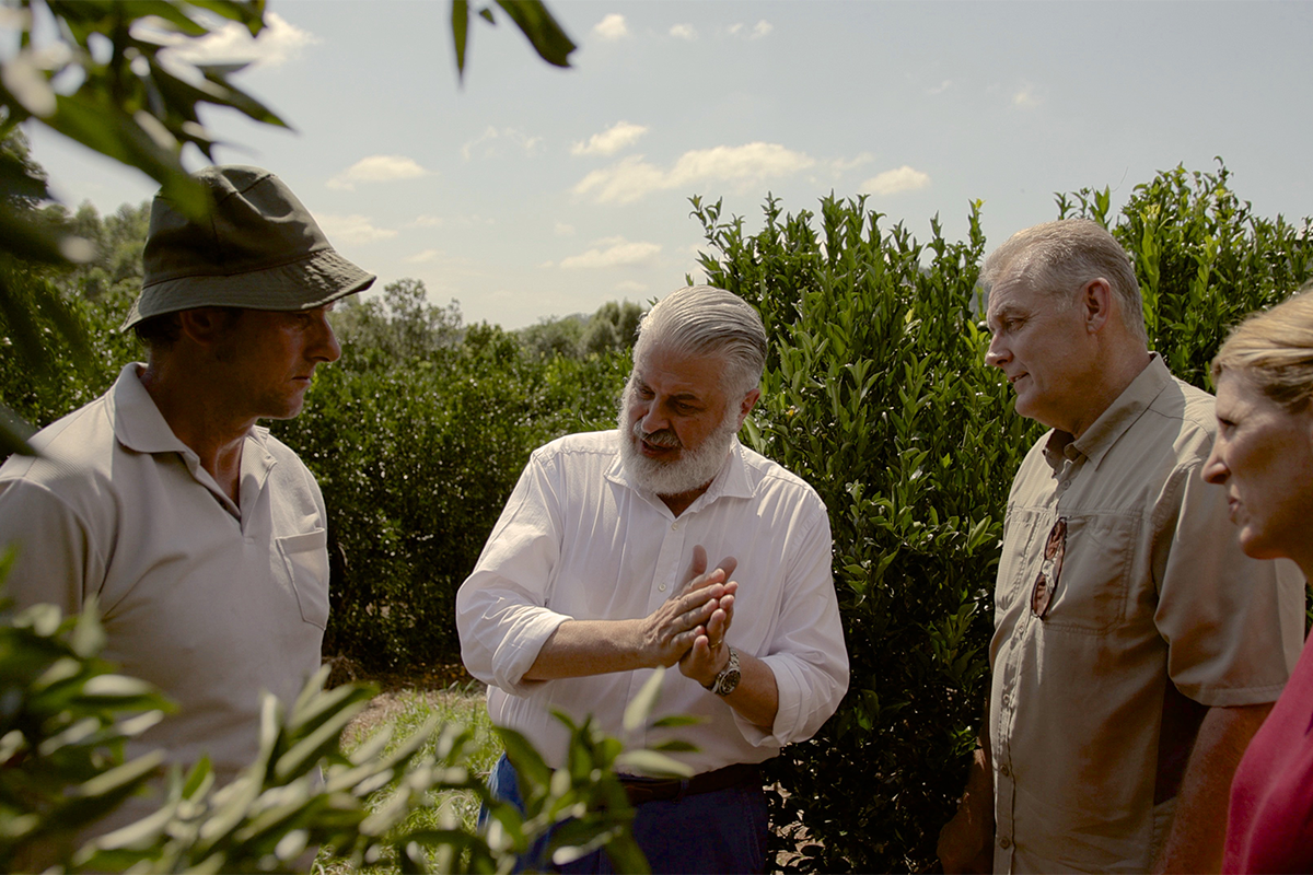 Enzo introducing Emily Wright and Dr. David Hill to a mandarin farmer